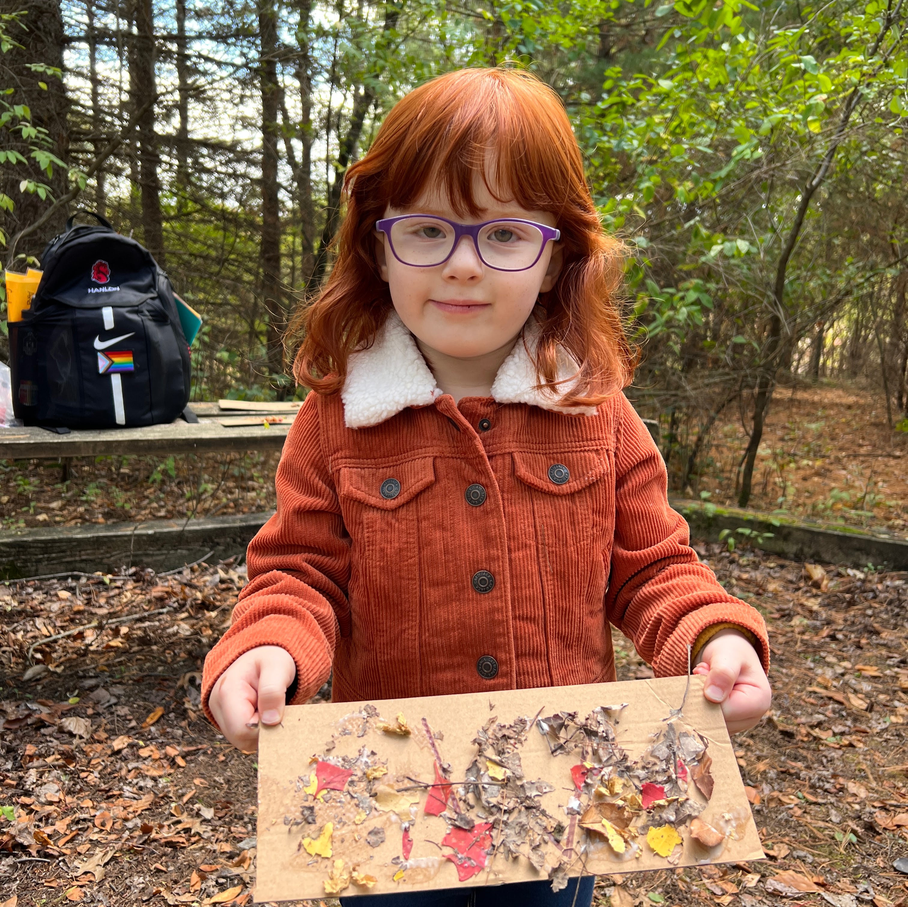 preschool child showing off leaf art